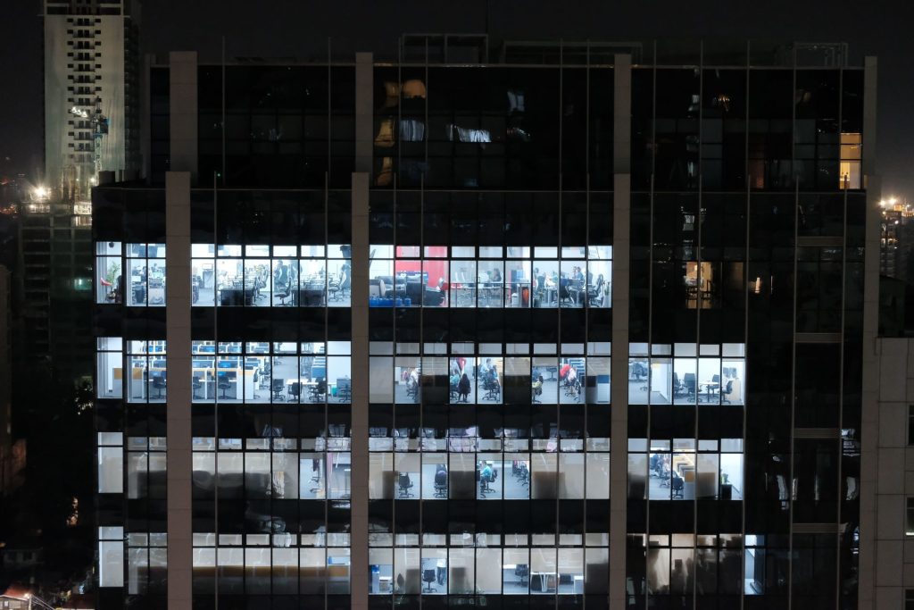 A night view of an office building in Central Visayas, Philippines, showcasing illuminated office windows.