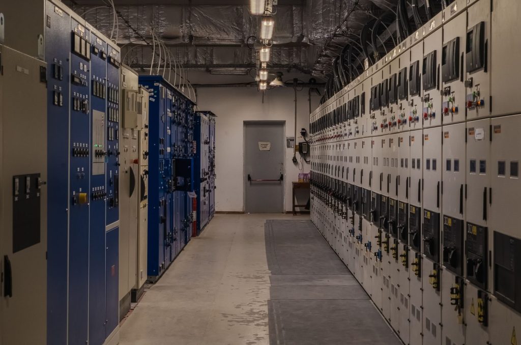 A sophisticated control room filled with electrical panels and equipment for industrial purposes.